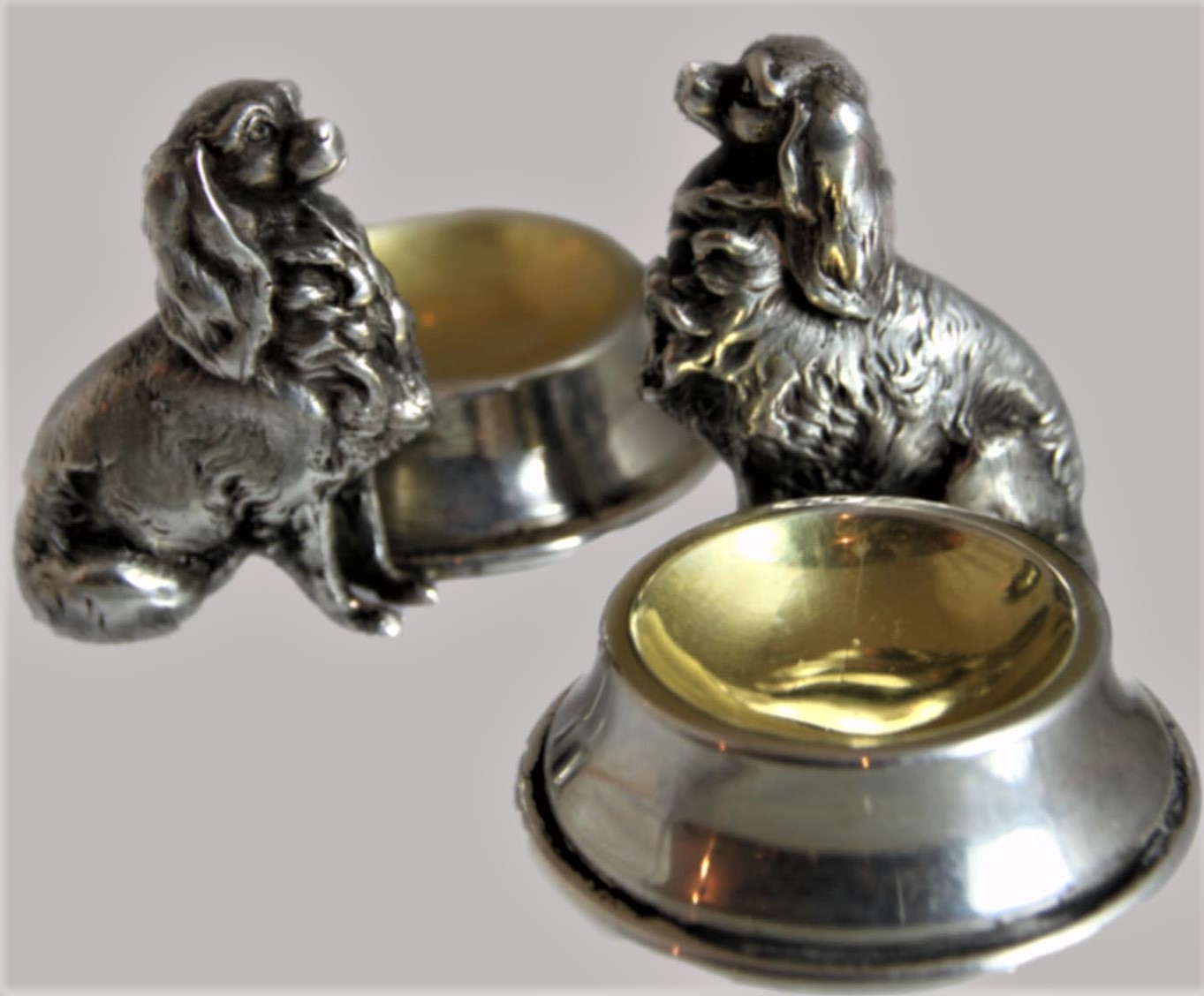 Click to see full size: A 19th century pair of silver plated King Charles Cavalier Spaniel salts